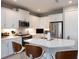 Bright kitchen boasts white cabinets, stainless steel appliances, and a spacious center island with barstool seating at 249 Tracino Ter, Nokomis, FL 34275