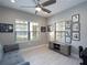 Comfortable living room with light wood floors and an entertainment center complemented by ample natural light at 249 Tracino Ter, Nokomis, FL 34275