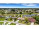 Aerial view of a residential area featuring a home with a canal in the backyard, in a neighborhood at 25509 Arequipa Dr, Punta Gorda, FL 33983
