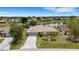 Aerial shot of home near a canal showcasing landscaping, a long driveway, and neighborhood setting at 25509 Arequipa Dr, Punta Gorda, FL 33983