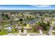 Aerial view of the home in a neighborhood setting with a canal, showing its proximity to amenities at 25509 Arequipa Dr, Punta Gorda, FL 33983
