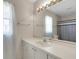 Bright bathroom with a large mirror, white vanity, and a shower/tub combo with a blue striped curtain at 25509 Arequipa Dr, Punta Gorda, FL 33983