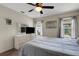 Bright bedroom with a ceiling fan, a TV, and two windows bringing in lots of natural light at 25509 Arequipa Dr, Punta Gorda, FL 33983