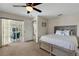 Calm main bedroom with en-suite bath, adjacent to screened patio, and a neutral color palette at 25509 Arequipa Dr, Punta Gorda, FL 33983