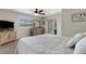 Comfortable bedroom offering a neutral palette, ensuite bathroom, and access to the outdoors at 25509 Arequipa Dr, Punta Gorda, FL 33983