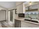 Gourmet kitchen features stainless steel appliances, granite counters, and a serene pool view at 25509 Arequipa Dr, Punta Gorda, FL 33983