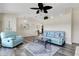 Open-concept living room featuring wood floors, bright lighting, and contemporary furnishings at 25509 Arequipa Dr, Punta Gorda, FL 33983