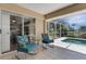 Cozy screened lanai boasts comfortable seating and a stunning view of the backyard and pool at 25509 Arequipa Dr, Punta Gorda, FL 33983