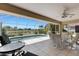 Spacious lanai offers a picturesque view of the pool and lush landscaping, perfect for outdoor dining at 25509 Arequipa Dr, Punta Gorda, FL 33983