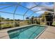 Sparkling pool within a screened enclosure, offering a serene view of the lake and landscaped surroundings at 25509 Arequipa Dr, Punta Gorda, FL 33983