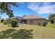 Beautiful pool area surrounded by a lush green lawn and mature flowering trees at 25509 Arequipa Dr, Punta Gorda, FL 33983