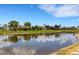 Scenic waterfront view of homes along a canal under a bright blue sky with scattered clouds at 25509 Arequipa Dr, Punta Gorda, FL 33983