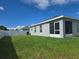 Expansive backyard with verdant lawn, screened lanai, and a crisp white privacy fence, perfect for serene outdoor living at 3003 58Th E Way, Palmetto, FL 34221