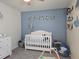 Charming Bedroom featuring crib, accent wall and decor at 3003 58Th E Way, Palmetto, FL 34221