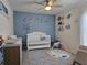 Charming Bedroom featuring crib, accent wall and decor at 3003 58Th E Way, Palmetto, FL 34221