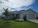 Charming single-story home featuring a well-manicured lawn and attached two-car garage at 3003 58Th E Way, Palmetto, FL 34221