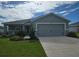 Charming single-story home with a well-manicured lawn and a two-car garage, showcasing curb appeal at 3003 58Th E Way, Palmetto, FL 34221