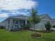 Charming one-story home with inviting front porch, seating, beautifully landscaped yard, and attached two-car garage at 3003 58Th E Way, Palmetto, FL 34221