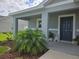 Inviting front porch adorned with lush landscaping and stylish decor at 3003 58Th E Way, Palmetto, FL 34221