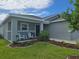 Inviting front porch features cozy seating and lush landscaping, perfect for enjoying the outdoors at 3003 58Th E Way, Palmetto, FL 34221