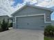 Close up of the home's two-car garage, showcasing its clean lines and attractive exterior lighting at 3003 58Th E Way, Palmetto, FL 34221