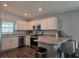 Bright kitchen featuring stainless steel appliances, white cabinetry, and a breakfast bar at 3003 58Th E Way, Palmetto, FL 34221