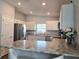 Bright kitchen featuring stainless steel appliances, white cabinetry, and a breakfast bar at 3003 58Th E Way, Palmetto, FL 34221