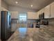 Modern kitchen featuring stainless steel appliances, white cabinets, and countertops at 3003 58Th E Way, Palmetto, FL 34221
