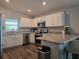 Bright kitchen featuring stainless steel appliances, white cabinetry, and a breakfast bar at 3003 58Th E Way, Palmetto, FL 34221