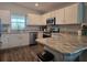Modern kitchen with stainless steel appliances, white cabinets, and stylish countertops at 3003 58Th E Way, Palmetto, FL 34221