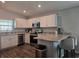 Bright kitchen featuring stainless steel appliances, white cabinetry, and a breakfast bar at 3003 58Th E Way, Palmetto, FL 34221