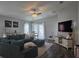 Inviting living room with a plush sectional sofa, ceiling fan, and sliding glass doors to the outdoors at 3003 58Th E Way, Palmetto, FL 34221