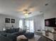 Cozy living space with TV, dining area, and comfortable teal sectional at 3003 58Th E Way, Palmetto, FL 34221