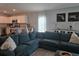 Spacious living room showcasing a teal sectional, flowing into a modern kitchen area at 3003 58Th E Way, Palmetto, FL 34221