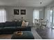 Comfortable living area with dining space, teal sectional, and white sheer curtains at 3003 58Th E Way, Palmetto, FL 34221
