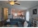 Bright, airy living space featuring a teal sectional sofa with an open view to a modern kitchen at 3003 58Th E Way, Palmetto, FL 34221