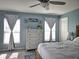 Cozy main bedroom showcasing a wooden bed frame, large windows, and a dresser at 3003 58Th E Way, Palmetto, FL 34221