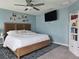 Spacious main bedroom with a wooden bed frame, ceiling fan, and a mounted television at 3003 58Th E Way, Palmetto, FL 34221