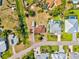 Aerial view highlighting a residence nestled in a serene neighborhood with mature trees, lush landscaping, and nearby amenities at 301 Gulf Dr, Venice, FL 34285