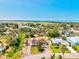 Scenic aerial view showcases a home in a lush, green neighborhood near an airport and the picturesque open water, creating a unique appeal at 301 Gulf Dr, Venice, FL 34285