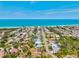 This aerial view captures a tranquil coastal neighborhood, highlighting homes and proximity to pristine beachfront at 301 Gulf Dr, Venice, FL 34285
