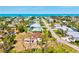 Breathtaking aerial view of a coastal community with houses, lush trees, and the ocean in the background at 301 Gulf Dr, Venice, FL 34285