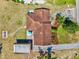 Aerial view displays the house featuring a tile roof, outdoor seating, and lush green landscaping, offering a private oasis at 301 Gulf Dr, Venice, FL 34285