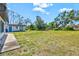 Large grassy backyard with mature trees and shrubs providing privacy and shade at 301 Gulf Dr, Venice, FL 34285