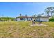 Wide angle view of backyard with patio seating area near the house and detached shed at 301 Gulf Dr, Venice, FL 34285