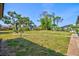 Spacious backyard with large mature trees and seating at 301 Gulf Dr, Venice, FL 34285