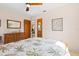 Comfortable bedroom with wood ceiling fan and natural light showcases a floral bedspread and dresser at 301 Gulf Dr, Venice, FL 34285