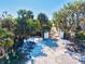View of a long driveway lined with trees and lush landscaping leading up to a home at 301 Gulf Dr, Venice, FL 34285
