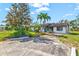 Charming home with well-manicured lawn and lush landscaping creates an inviting curb appeal and serene outdoor space at 301 Gulf Dr, Venice, FL 34285