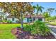 Charming single-story home with lush landscaping, mature trees, and a well-manicured lawn at 301 Gulf Dr, Venice, FL 34285